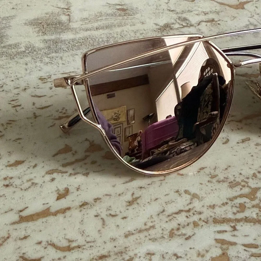 Rose gold wire frame cat eye aviator sunglasses with reflective pink lenses.
